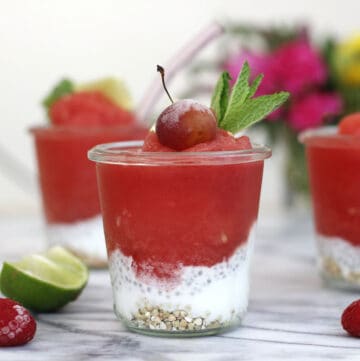 watermelon slush in a cup with yogurt and a cherry on top