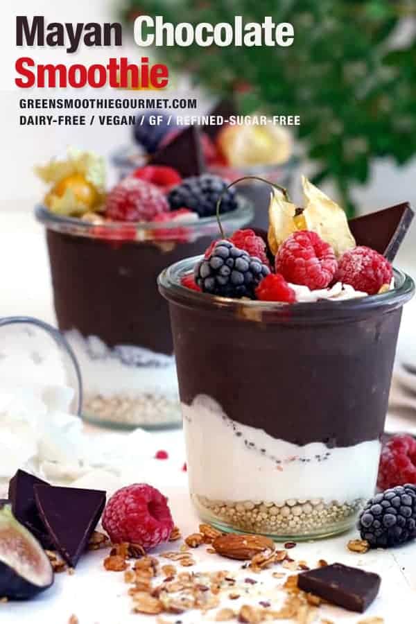 Two mayan chocolate smoothies layered with cashew cream and fruit.
