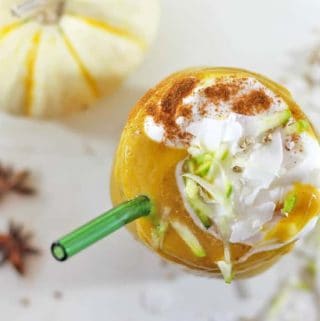 Overhead view of a pumpkin pie smoothie with cinnamon and yogurt on top.