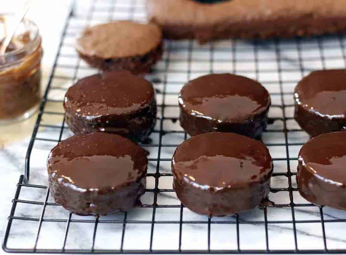 rows of ring ding cakes on a cooking rack