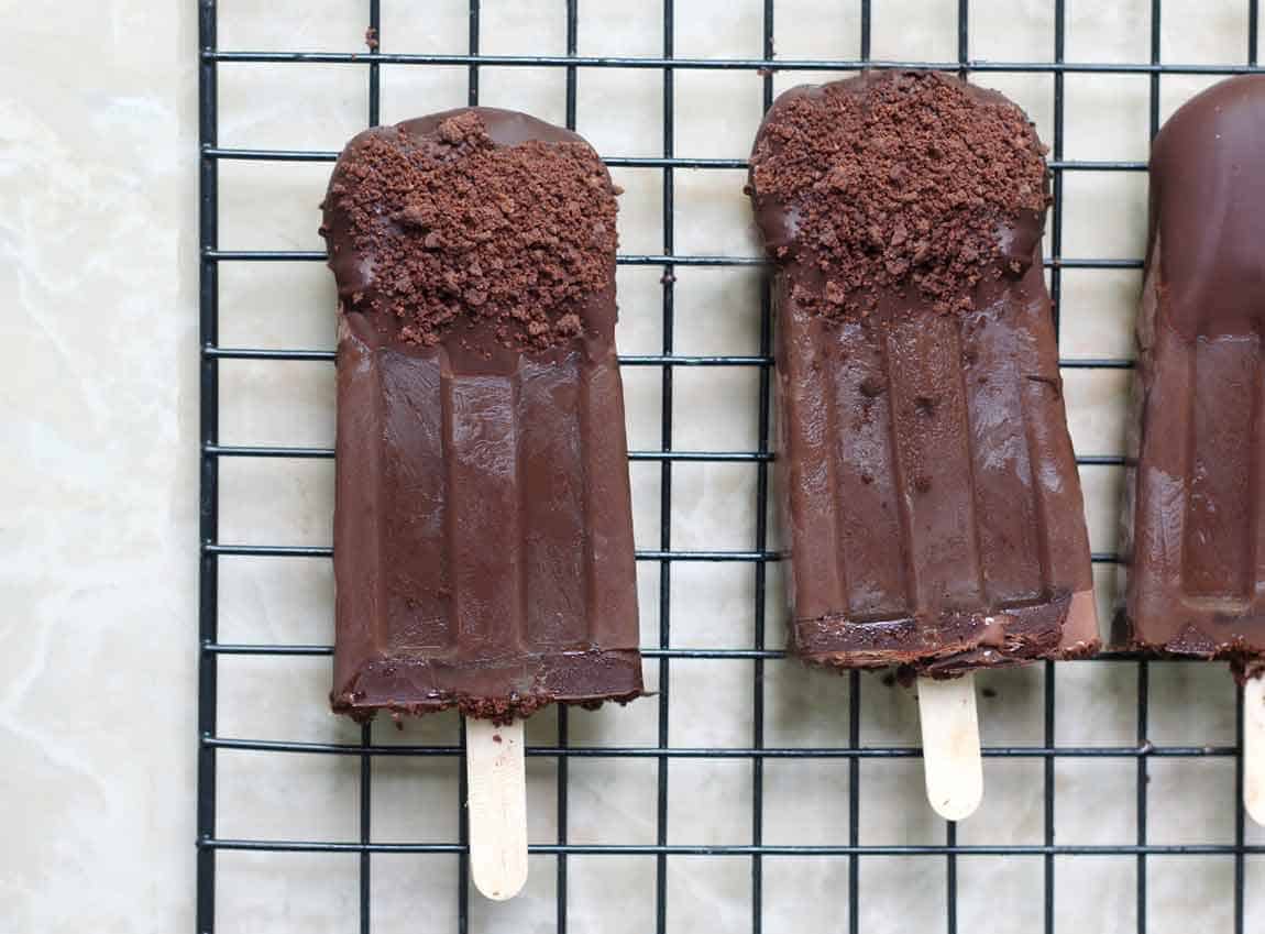 chocolate avocado popsicles on a cooling rack.