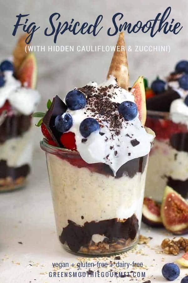 A jar with yogurt, fig smoothie, chocolate sauce and berries on top as well as upside down ice cream cones.
