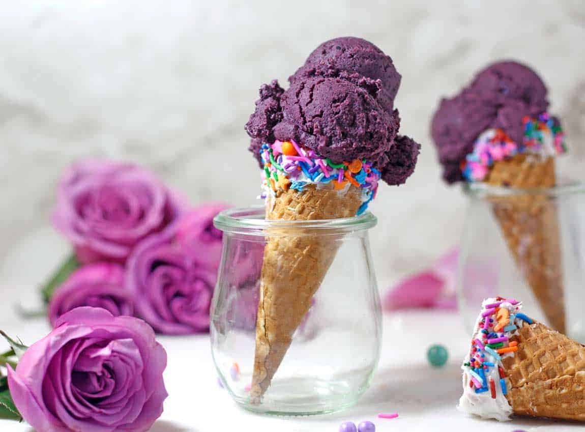 a cone with blueberry ice cream in a glass.