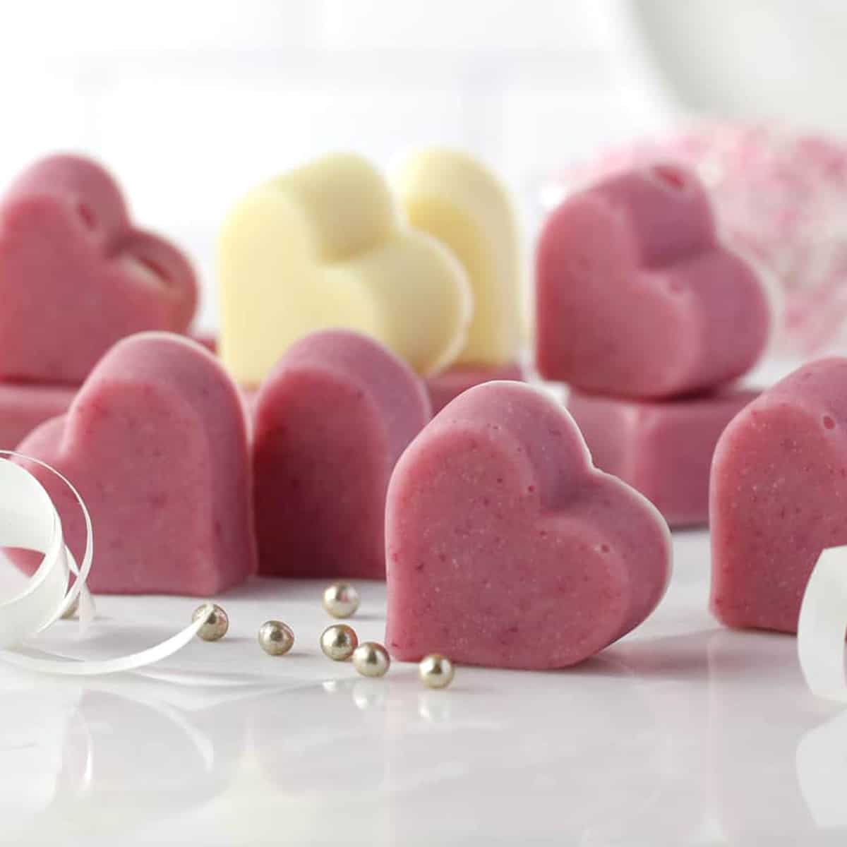 lots of pink hearts and a white heart on marble