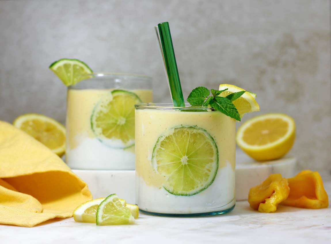 Lemon smoothie jackfruit recipe in a glass with a slice of lime pressed on to the side