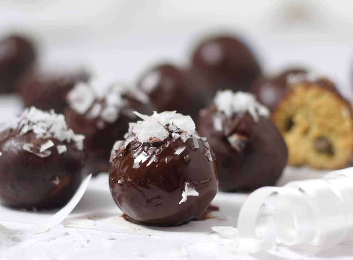 Edible Chocolate Chip Cookie dough balls on a white board.