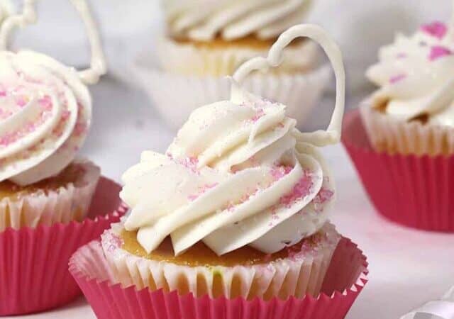 cupcakes with buttercream piped on top and pink paper cups