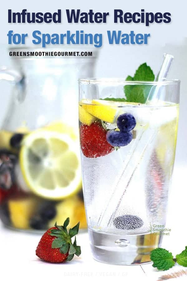 Glass of sparkling water with fruit and veggies floating, a glass straw and a pitcher of sparkling infused water in the background.