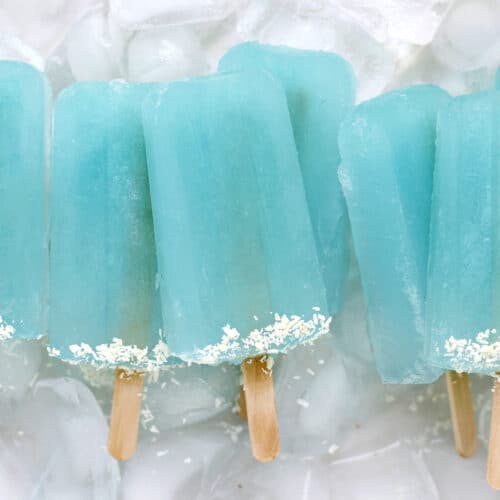 bright blue popsicles in a pile on ice