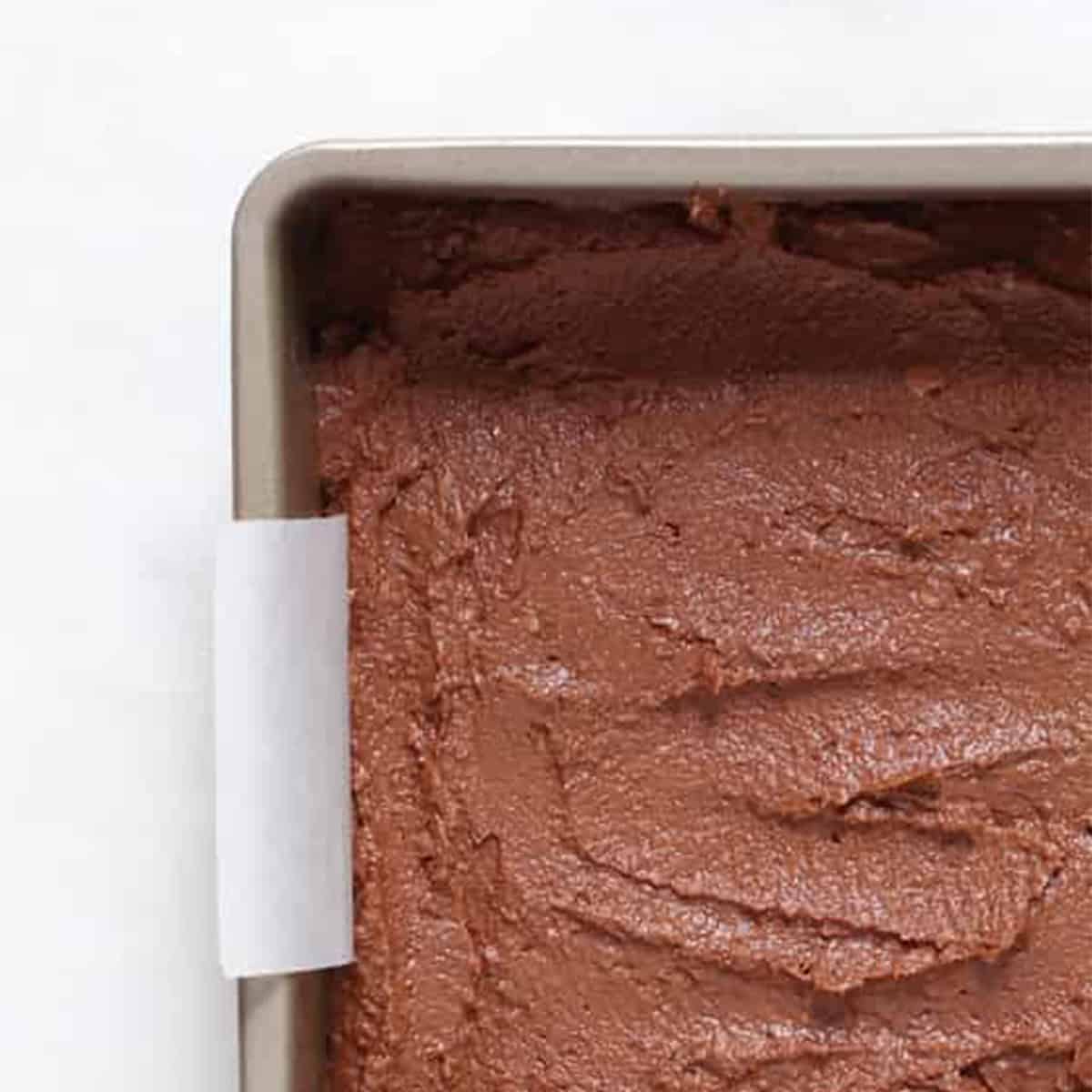 pumpkin brownie batter in a pan.