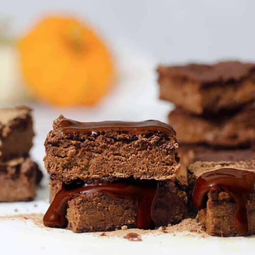 pumpkin brownies in a stack with chocolate glaze.