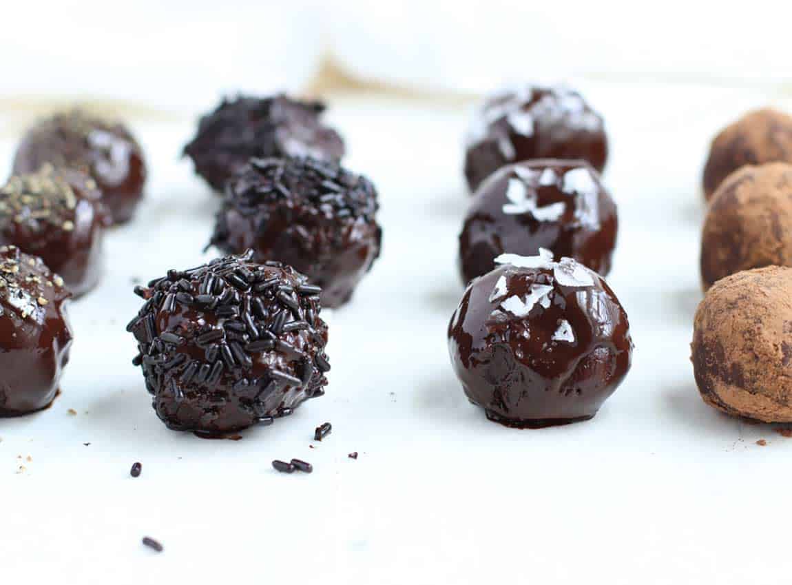 Black Pepper Chocolate Truffles lined up in rows.en-free)