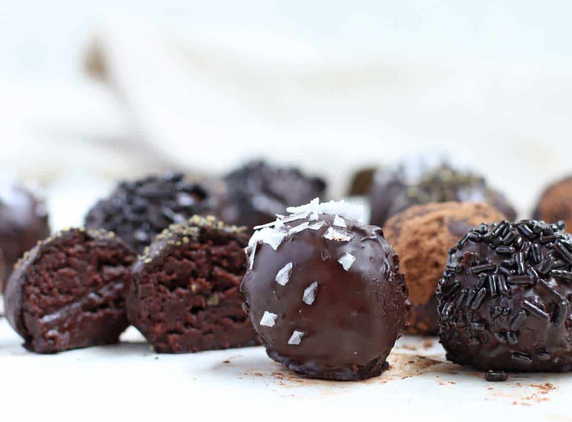 Black Pepper Chocolate Truffles lined up in a cluster.