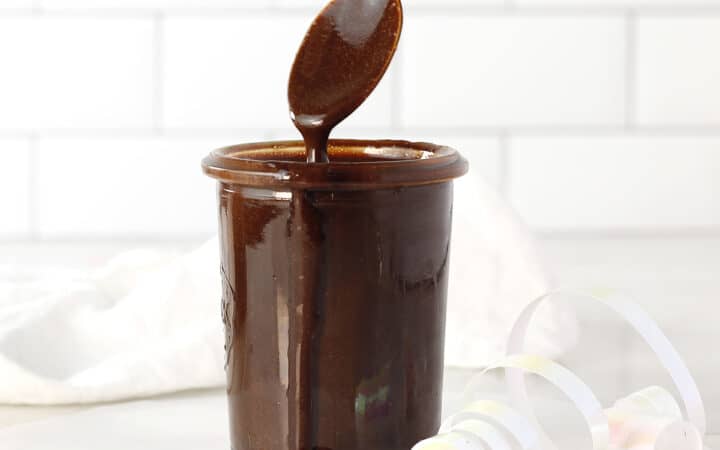 chocolate sauce in a jar with a spoon