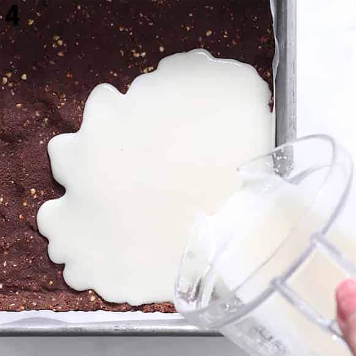 coconut layer poured on chocolate coconut bar.