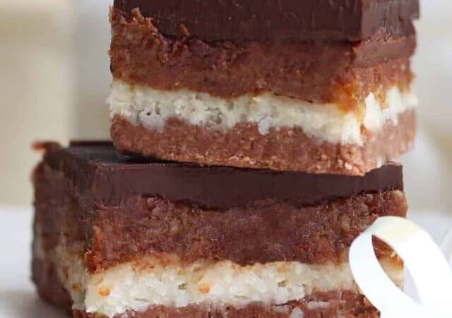 a stack of caramel bars with a white ribbon