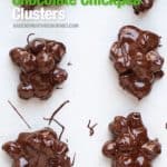 Chickpeas dipped in chocolate in clusters on a white board