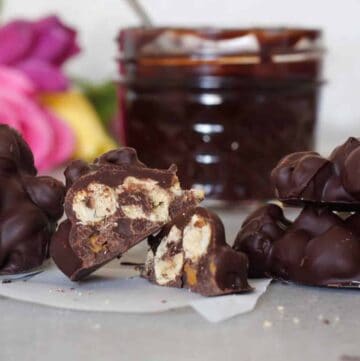 chocolate covered chickpeas and a cup of fudge sauce.