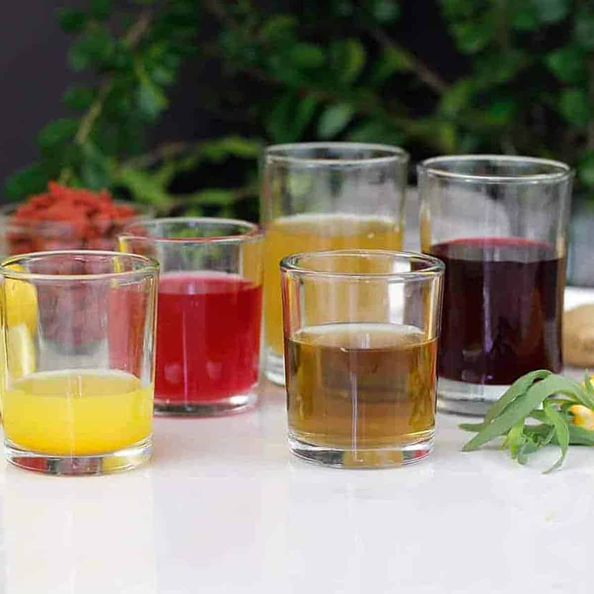 5 wellness shots in glasses on a table