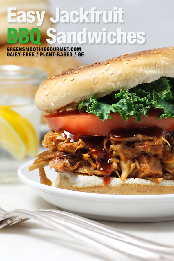 Jackfruit BBQ sandwich in a bun with tomato and kale in a toasted bun.