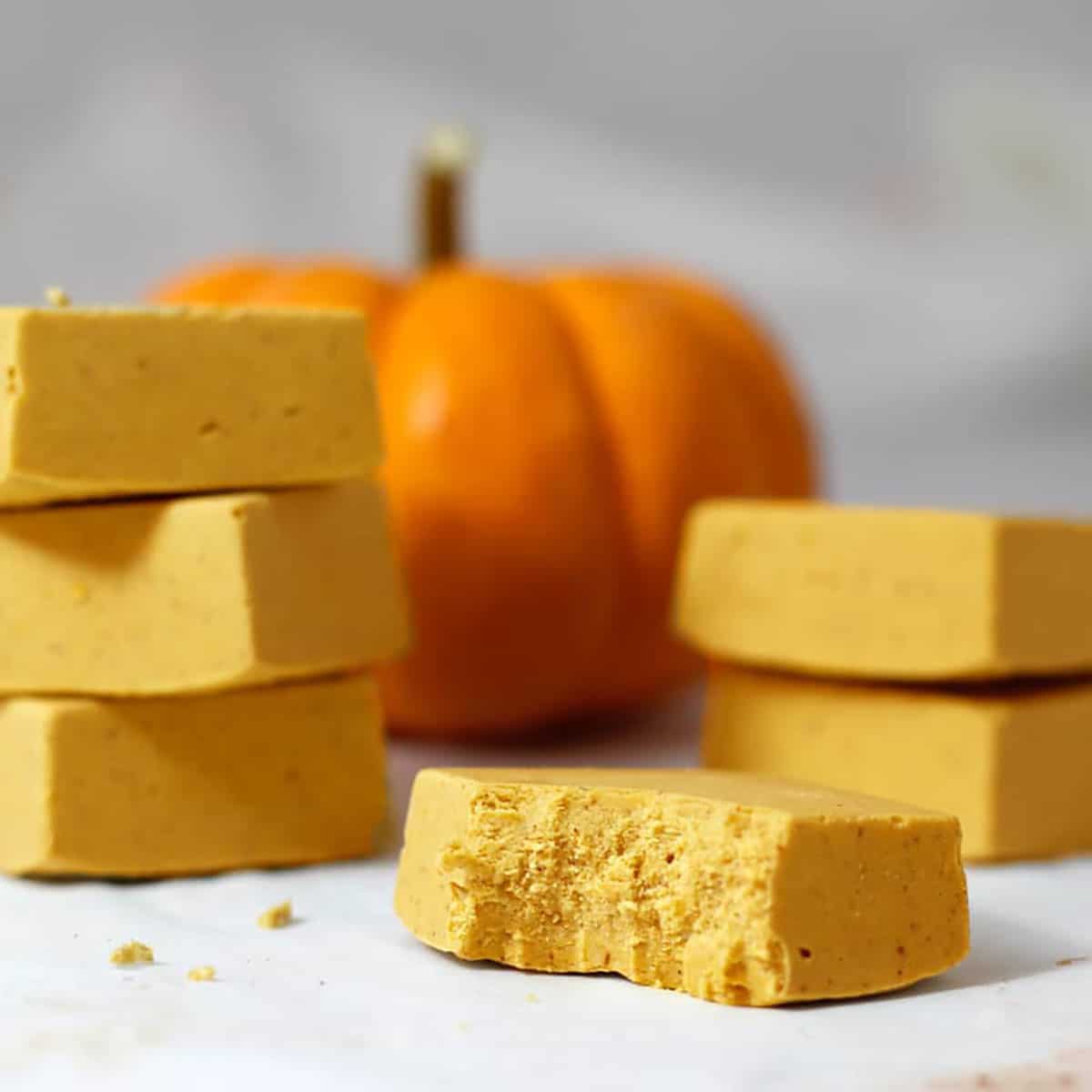 little squares of pumpkin fudge with one bitten in front.