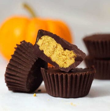 pumpkin fudge in a chocolate cup, leaning on another.