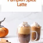 pumpkin spice latte in a mug with a pumpkin.