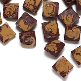 Sunbutter marble fudge squares in a pattern on a white table.