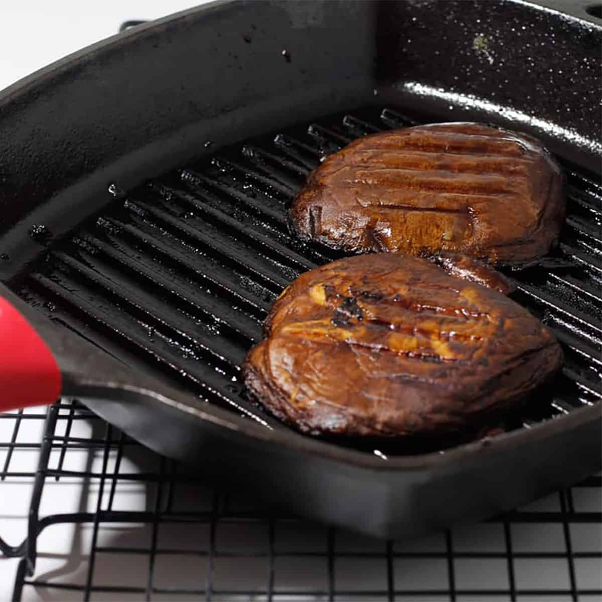 grilled portobello steaks in a pan.