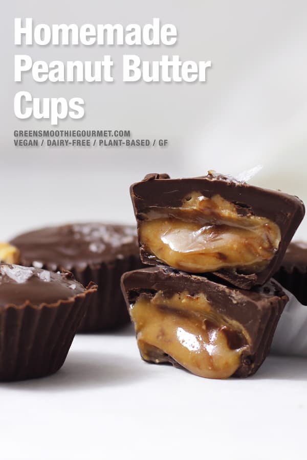 Tower of homemade peanut butter cups with both cut open and spilling out golden creamy peanut butter.