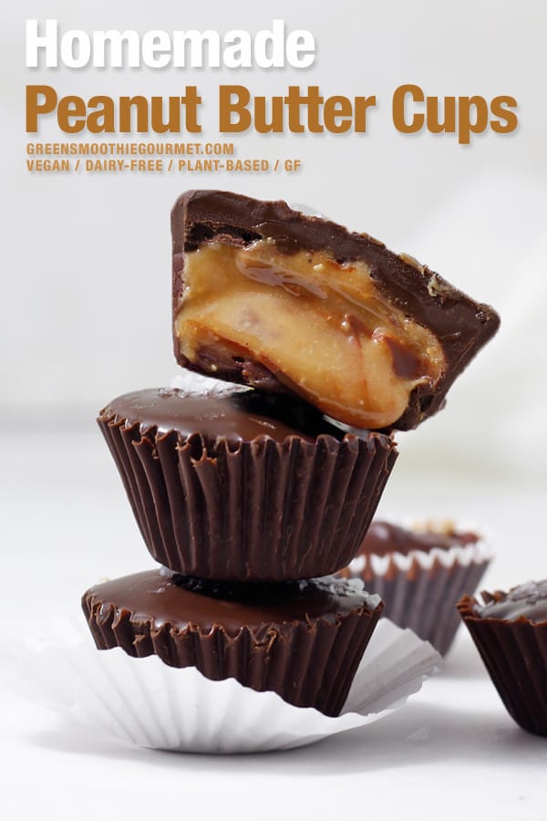 Tower of homemade peanut butter cups with the top one cut open and spilling out golden creamy peanut butter.