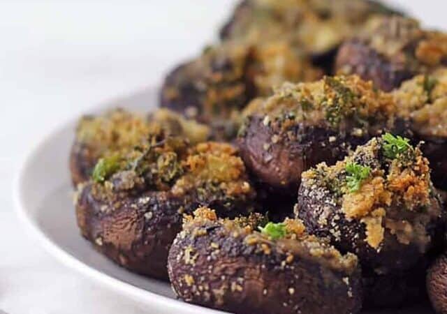 stuffed mushrooms in a platter in a stack.