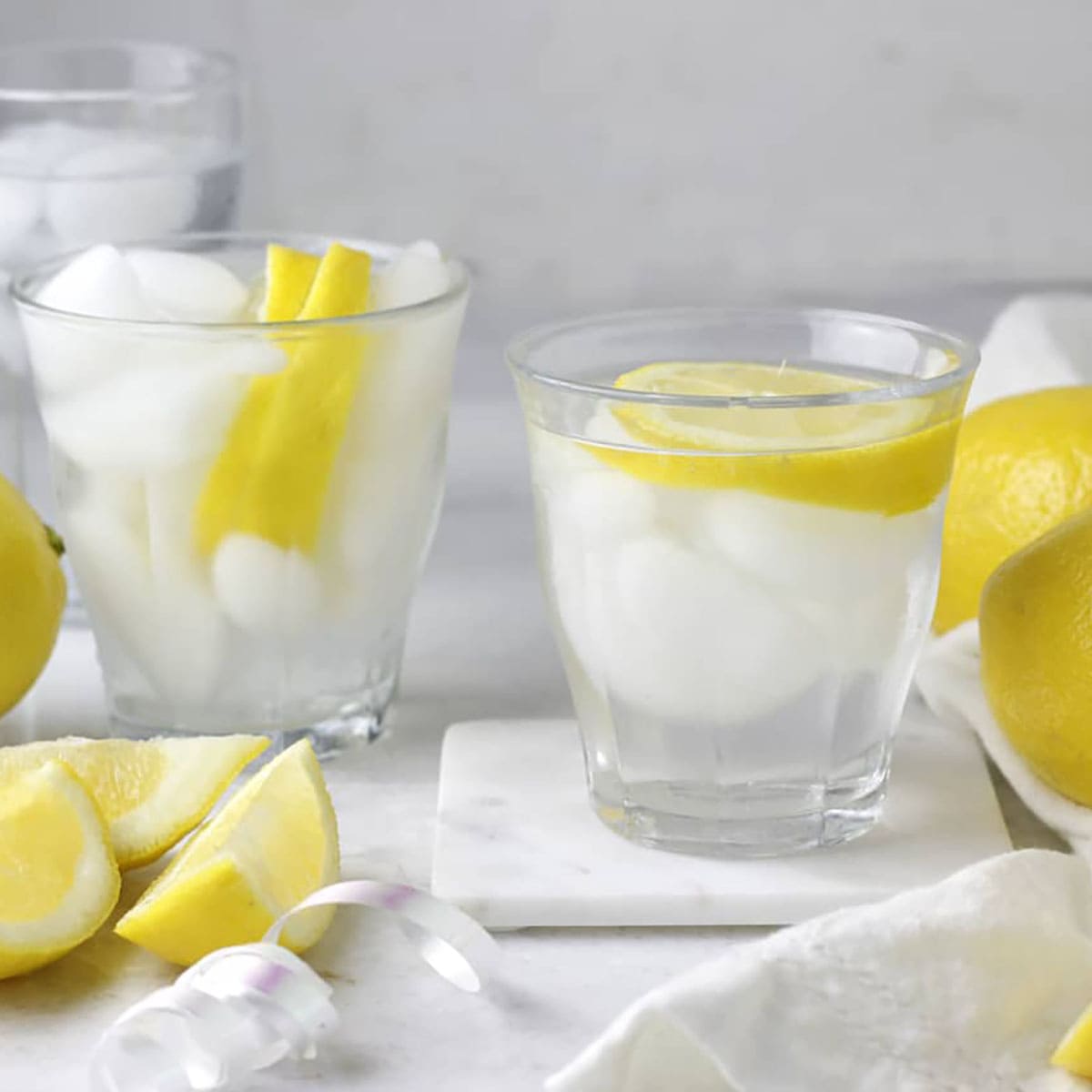 cold lemon water in glasses on a table.