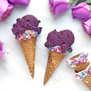 two blueberry ice cream cones on their side
