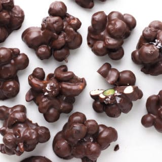 Blueberry Chocolate Cashew Clusters on white paper.
