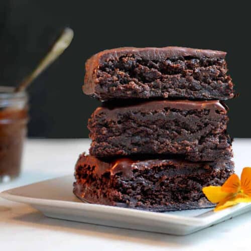stack of 3 brownies on a white dish