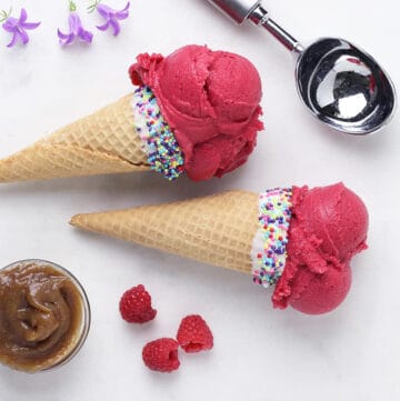 two raspberry ice cream cones on their side