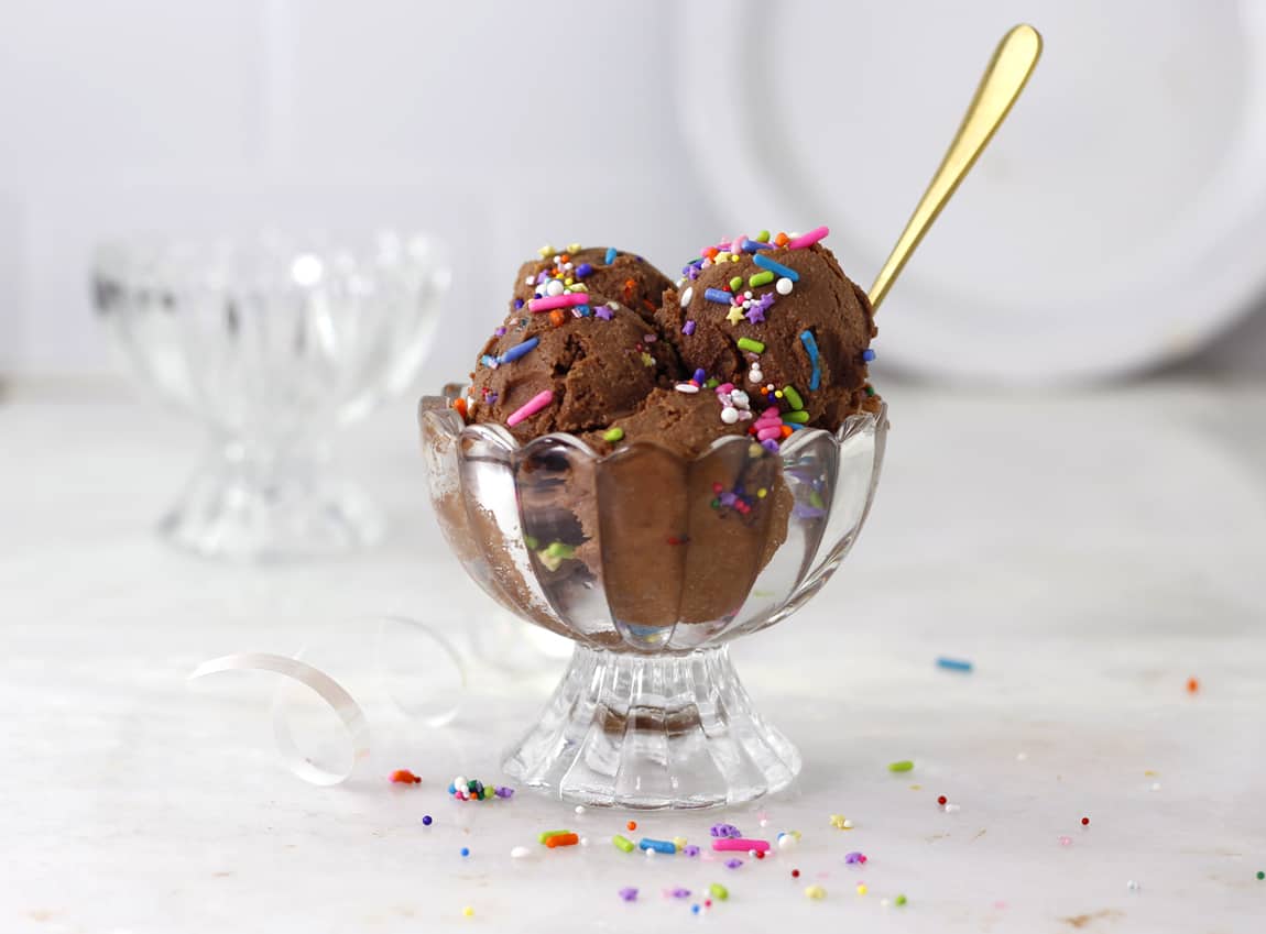 Edible Brownie batter in a scalloped ice cream bowl with sprinkles.