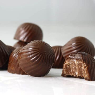 oval chocolates on a table with a bite out