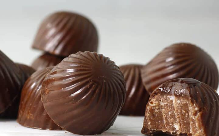 oval chocolates on a table with a bite out