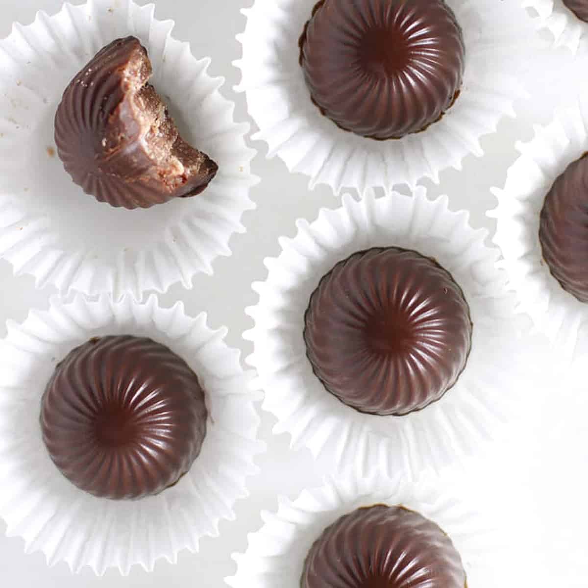 overhead of oval chocolates on a table with one bitten