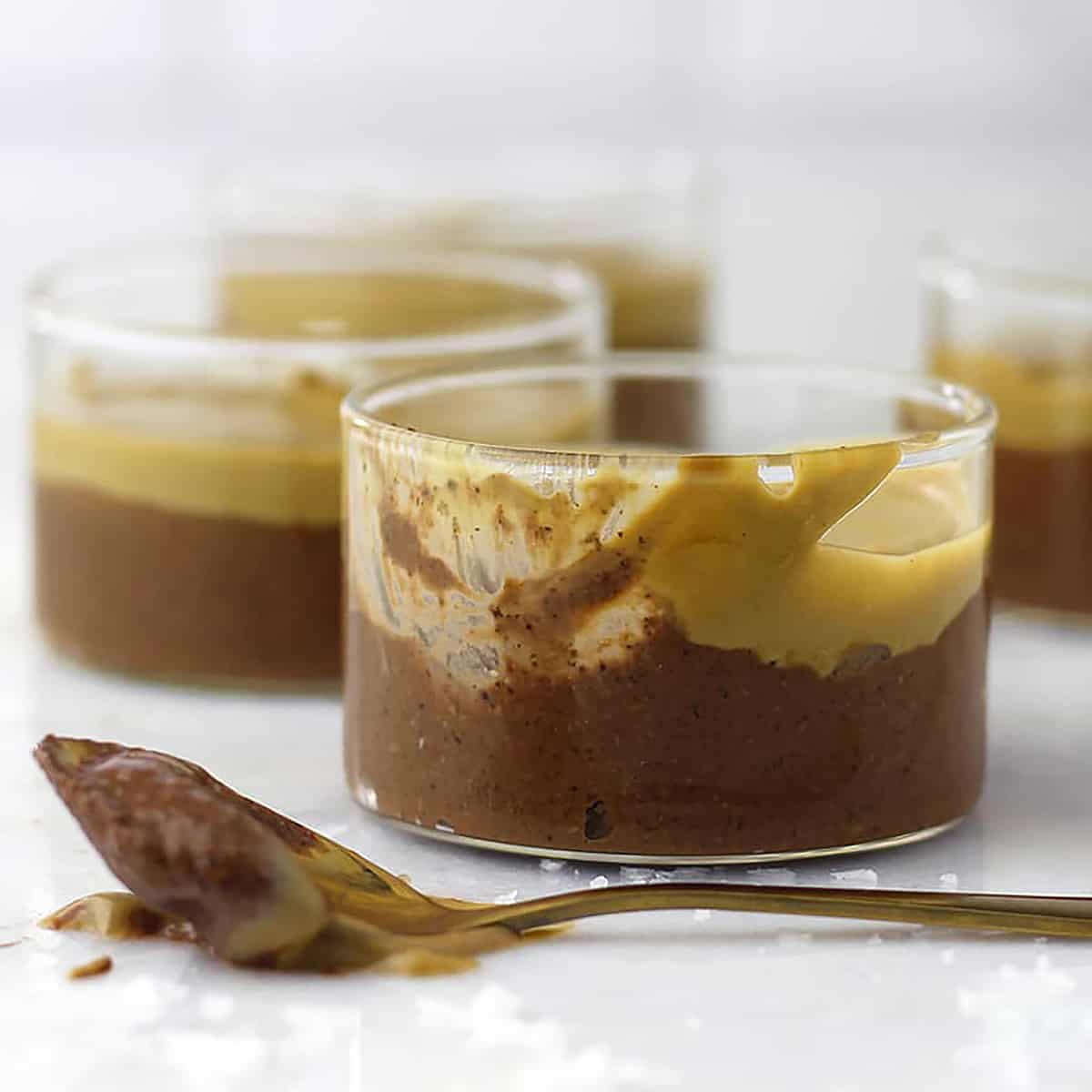 a cup of chia pudding with caramel top with a spoonful removed