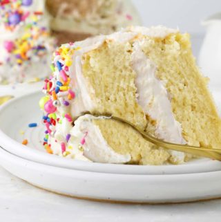 Vanilla vegan cake sliced with cake in background.ound.