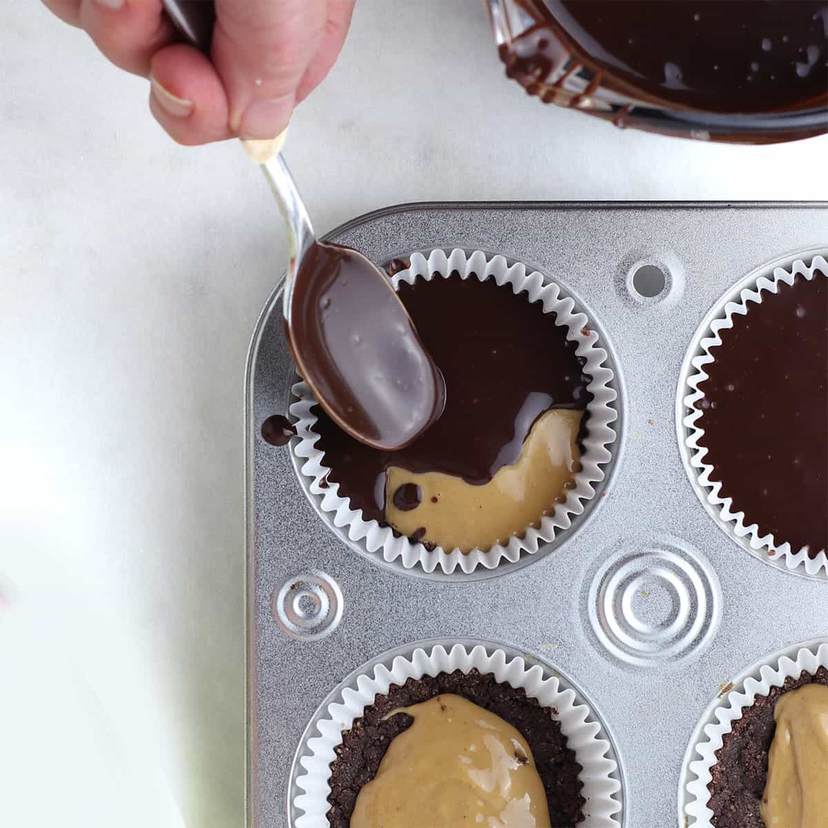 chocolate peanut butter cups with spoon adding chocolate.