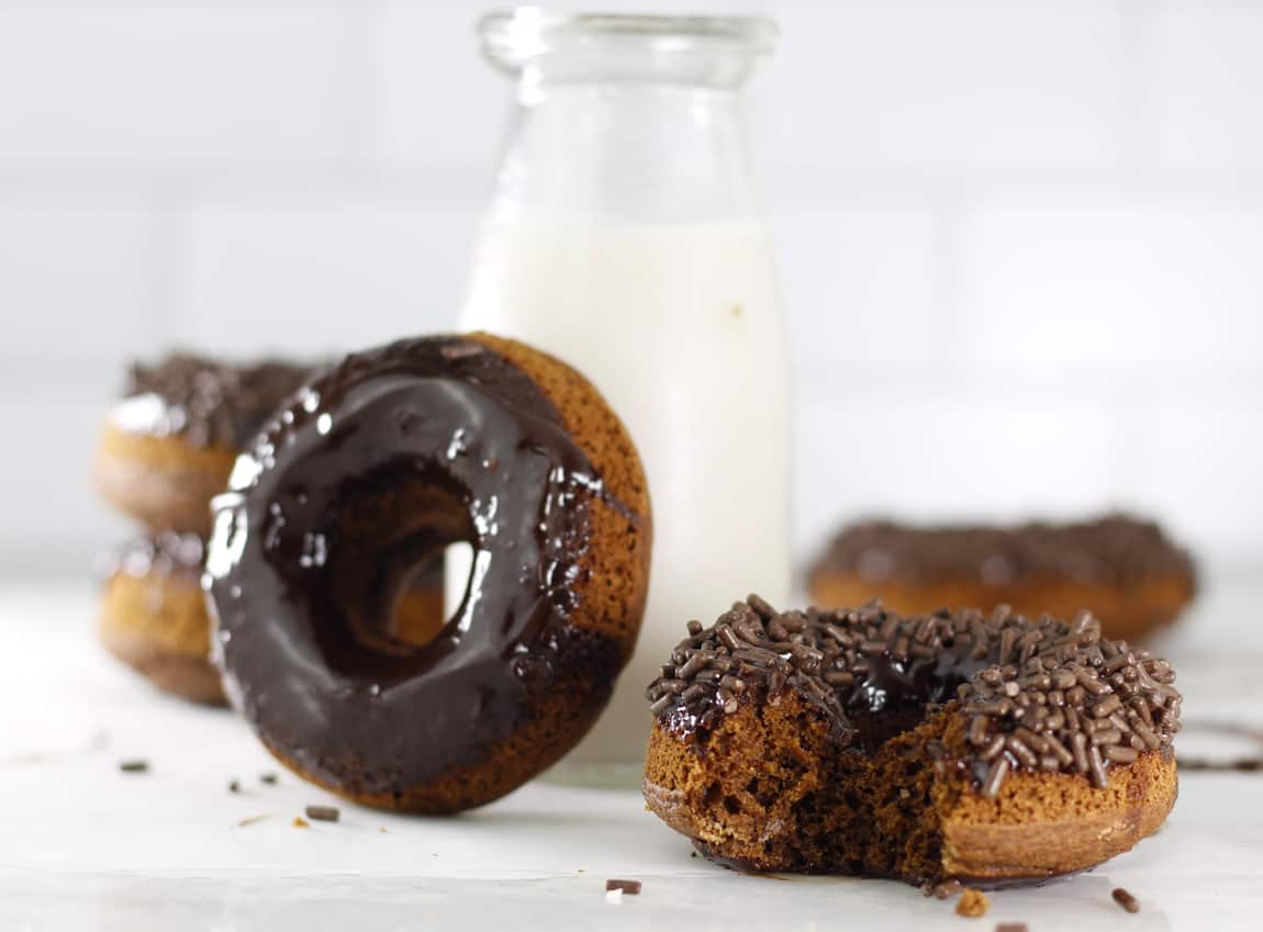 chocolate frosted donuts on marble board.
