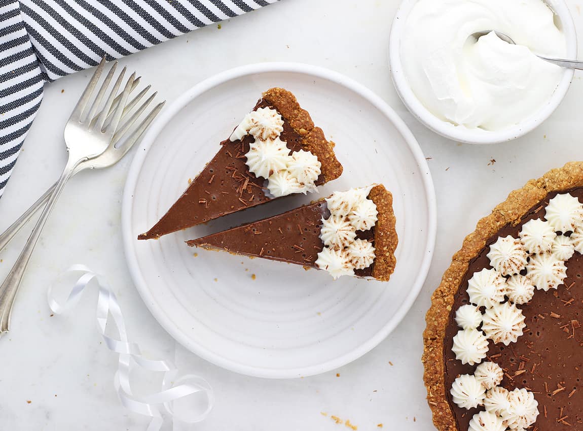 Slices of healthy chocolate cream pie on a white dish.
