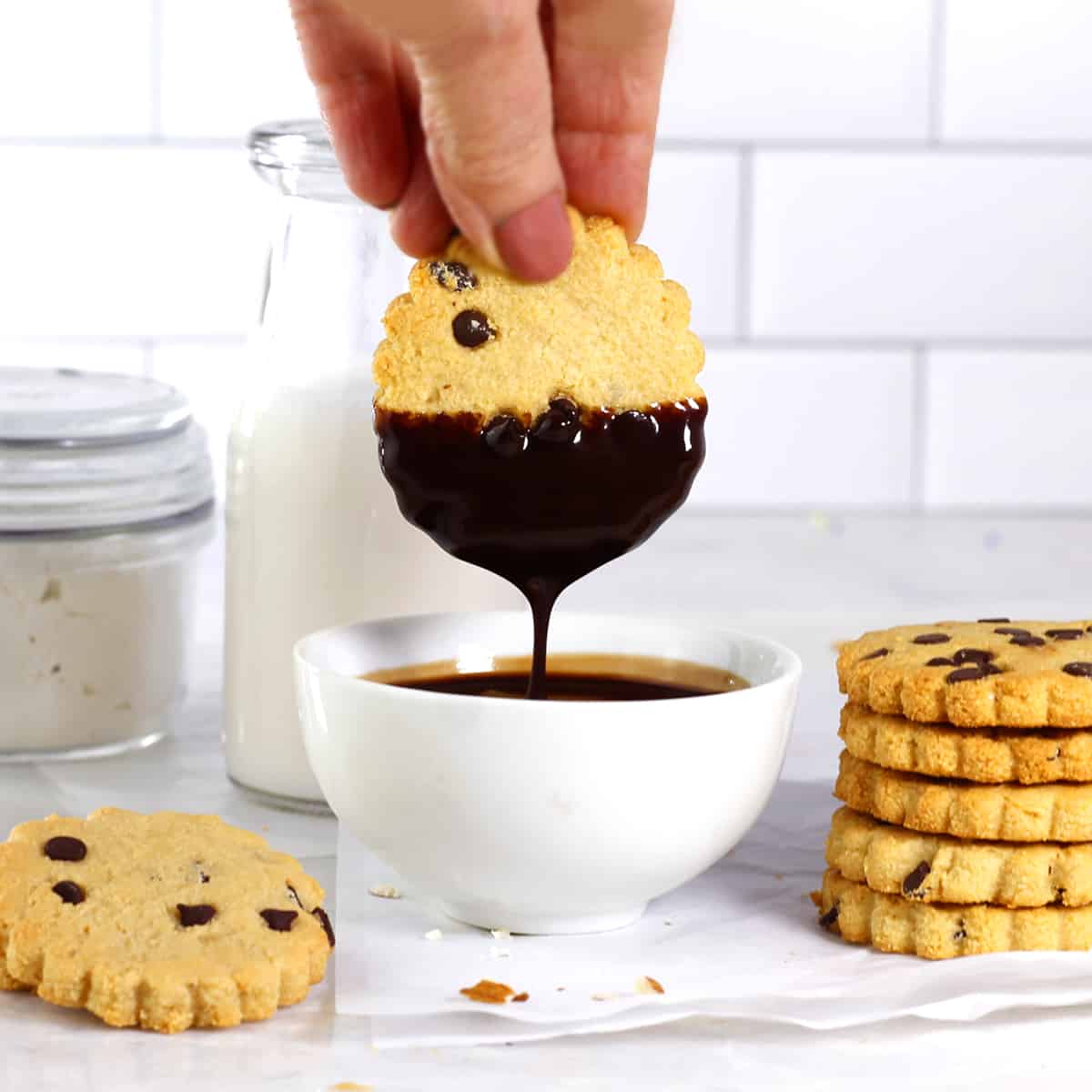 a shortbread cookies being dipped in chocolate