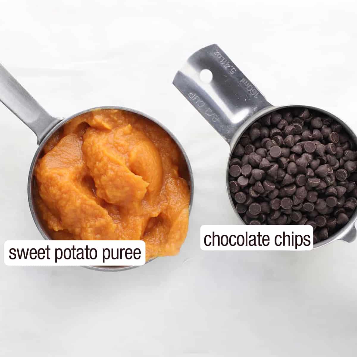 overhead shot of sweet potato puree and chocolate chips in silver measuring scoops