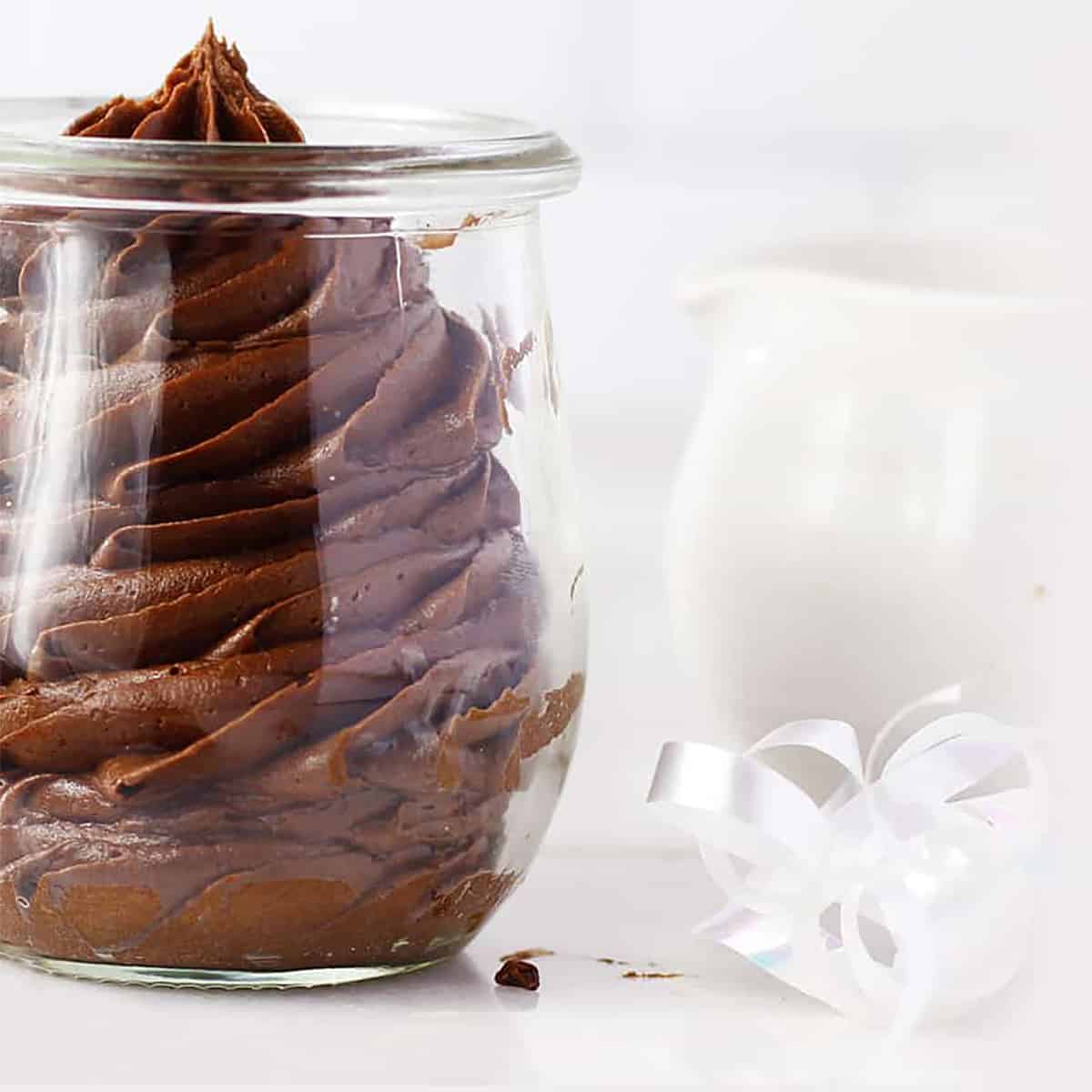 a jar full of piped chocolate fudge frosting.