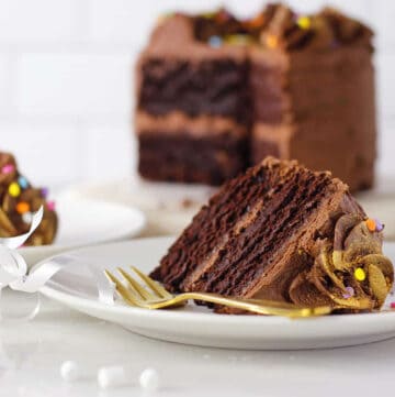 a slice of cake with fudge frosting and fork